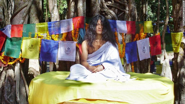 Ram Bahadur Bomjan sits on a platform before preaching to an audience in Bara district, 62 miles south of Kathmandu, in this file photograph from November 10, 2008.