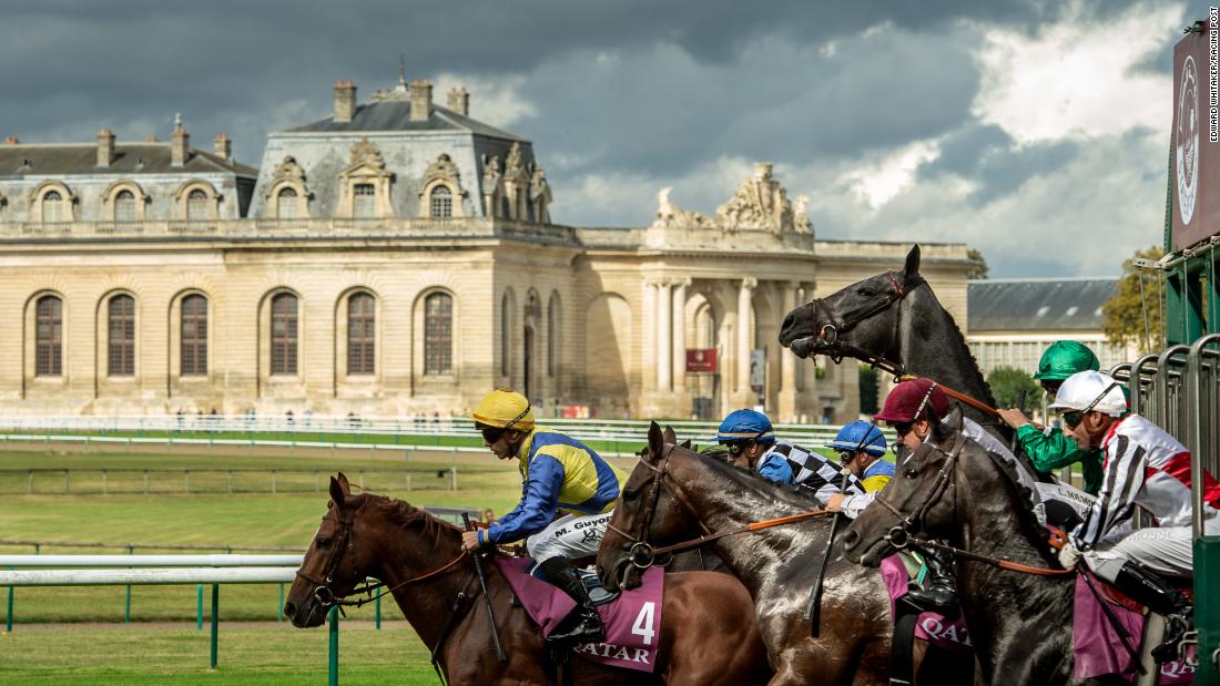 Horses break from the stalls in front of the Great Stables at Chantilly, France in 2016. &quot;I love this shot because of the light and the horse rearing  at the start. It&#39;s just a dramatic picture. That one horse going up gives it great strength.&quot;