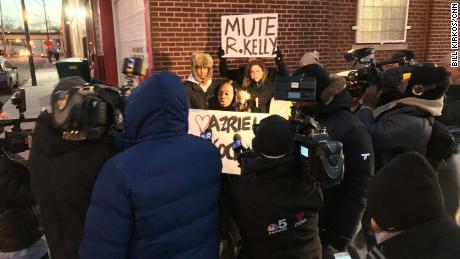 Protesters outside R. Kelly's studio in Chicago call for a boycott of his music. 