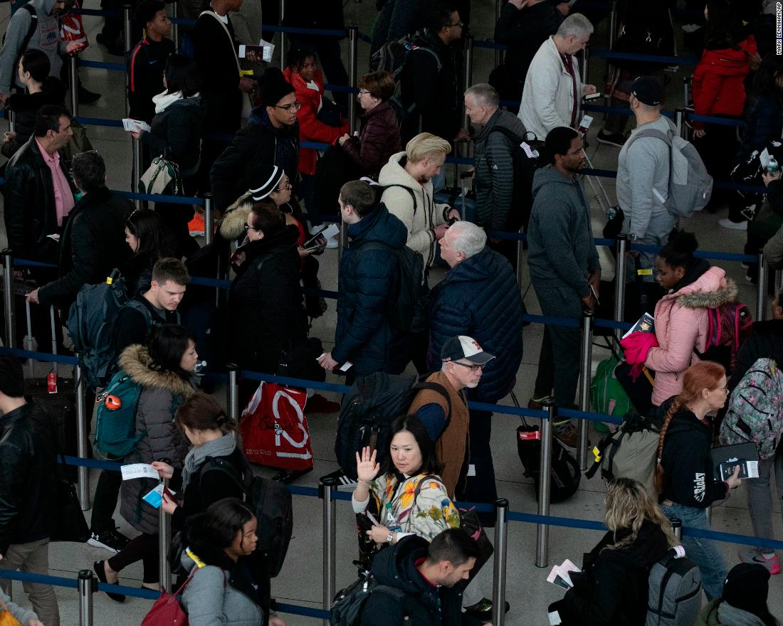 Passengers wait in line at New York&#39;s John F. Kennedy International Airport on Monday, January 7.