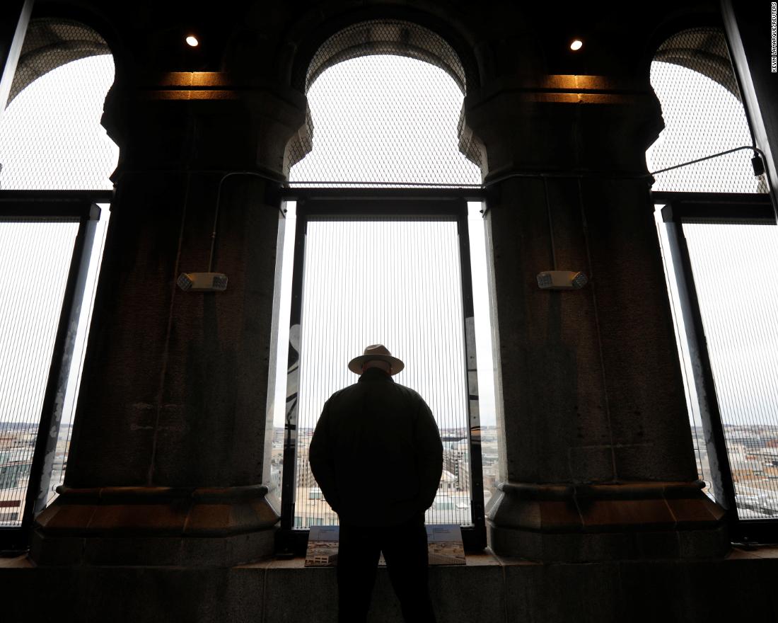 A National Park Service ranger looks out onto Washington from the Trump International Hotel&#39;s historic clock tower.