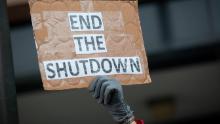 OGDEN, UT - JANUARY 10: A demonstrator holds a sign protesting the government shutdown at the James V. Hansen Federal Building on January 10, 2019 in Ogden, Utah. As the shutdown nears the three week mark, many federal employees will not receive a paycheck tomorrow. 
