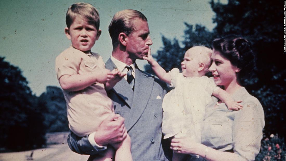 Philip and Elizabeth hold their children Prince Charles and Princess Anne in August 1951.