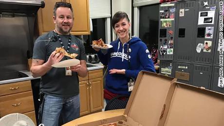David Heady and Julie Lytle, air traffic controllers in Portland, Maine, were treated to pizza by Canadian air traffic controllers.