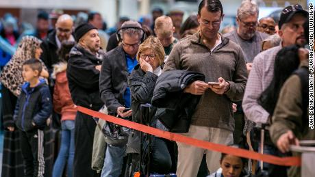 Security lines at Hartsfield-Jackson International Airport in Atlanta stretch more than an hour long amid the partial federal shutdown, causing some travelers to miss flights, Monday morning, Jan. 14, 2019. There were at least six security lanes closed at domestic terminal security checkpoints reflecting staffing shortages as TSA officers have been working without pay since the federal shutdown began Dec. 22. (John Spink/Atlanta Journal-Constitution via AP)