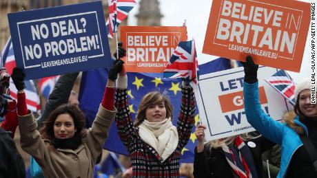 Pro-Brexit supporters hold up placards outside the UK Parliament as MPs debated.