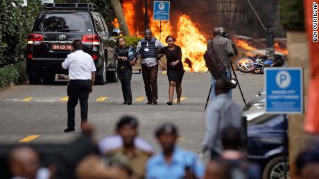 Security forces help civilians flee the scene of a terror attack in Nairobi. 