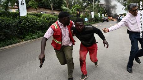 An injured man is evacuated from the scene of an explosion at a hotel complex in Nairobi's Westlands suburb on January 15, 2019, in Kenya. - A gunfight was underway following the blast in the leafy Nairobi neighbourhood, an AFP reporter and a witness said. It was not immediately clear whether the incident was a robbery or an attack. (Photo by SIMON MAINA / AFP)        (Photo credit should read SIMON MAINA/AFP/Getty Images)