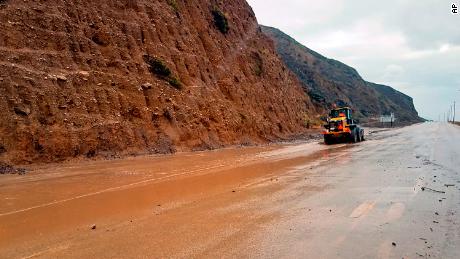 A skiploader clears mud on the Pacific Coast Highway in Malibu Monday.