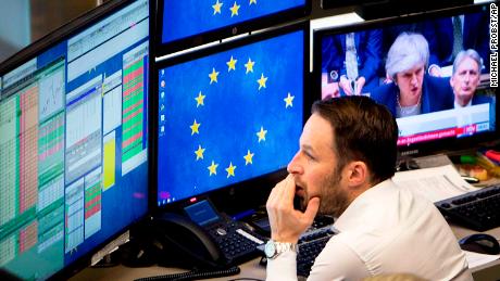 A broker watches news coverage of Brexit. 