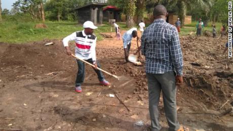 Locals repair the Rwangoma health clinic, which had been vandalized by election protesters.