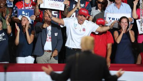 People cheer as President Donald Trump looks at them during a campaign rally at the Hertz Arena to help Republican candidates in the midterm elections on October 31, 2018, in Estero, Florida.