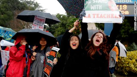 Teacher Maria Arienza, right, rallies next to student Stephanie Medrano outside North Hollywood High. 