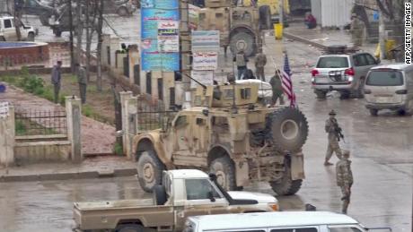 An image grab taken from a video obtained by AFPTV on January 16, 2019, shows US troops gathered at the scene of a suicide attack in the northern Syrian town of Manbij. - A suicide attack targeting US-led coalition forces in the flashpoint northern Syrian city of Manbij killed a US serviceman and 14 other people today, a monitor said. (Photo by - / various sources / AFP)        (Photo credit should read -/AFP/Getty Images)