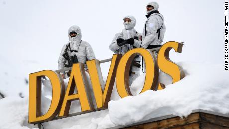 Armed security personnel stand guard on a rooftop in Davos.