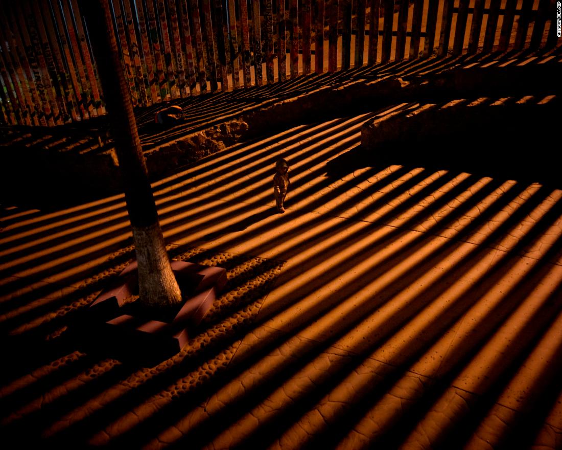 A child plays along the border wall in Tijuana, Mexico, on Friday, January 11.