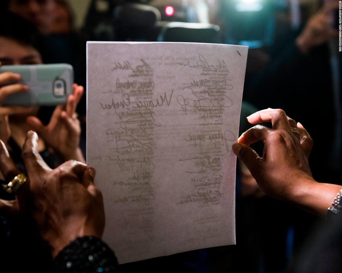 US Rep. Jahana Hayes, D-Connecticut, holds a letter January 16 that was delivered to Senate Majority Leader Mitch McConnell&#39;s office, urging the Senate to act on House-passed legislation to reopen the government.