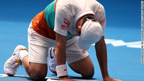 Kei Nishikori dropped to the court in joy after beating Ivo Karlovic at the Australian Open Thursday. 