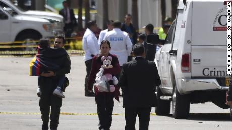 People evacuate the area near Bogota's General Santander National Police Academy after the blast. 