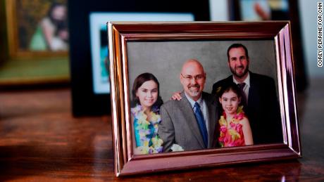 A family portrait in Steven Wall's office. From left are daughters Jessica and Carolina and his oldest son, Zachary.