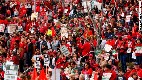 A sea of teachers, parents and students rallied in the rain Friday during day 5 of the teachers' strike. 