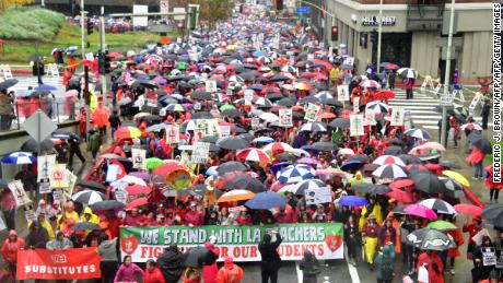 Thousands of teachers marched in the rain demanding more school staffing and higher salaries. 