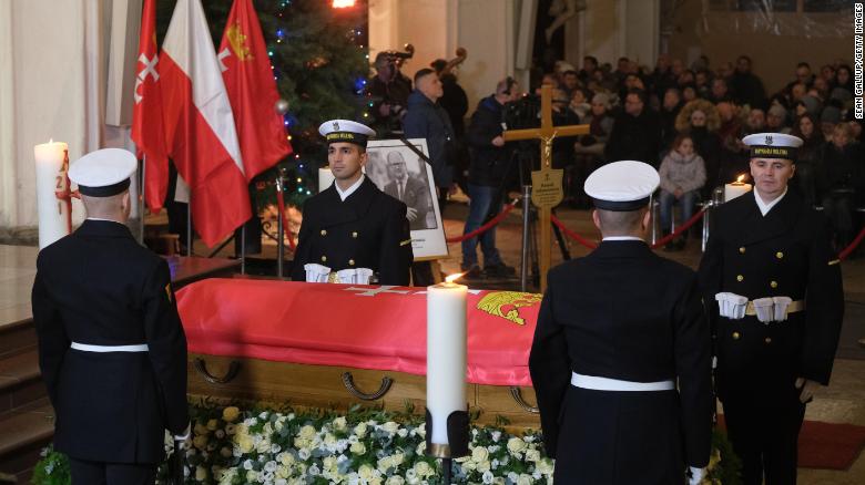 Ceremonial guards stand by the coffin of Pawel Adamowicz during a Catholic mass at St. Mary&#39;s Basilica following a procession through Gdansk on Friday.