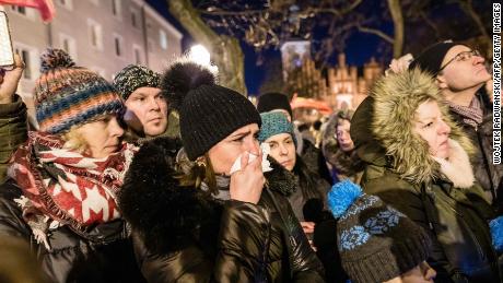 People mourn as the coffin of Pawel Adamowicz is taken from the European Solidarity Center to St Mary's Basilica on Friday.