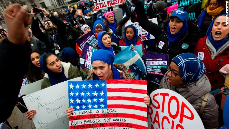 A group holds up signs Saturday at Washington&#39;s Freedom Plaza.