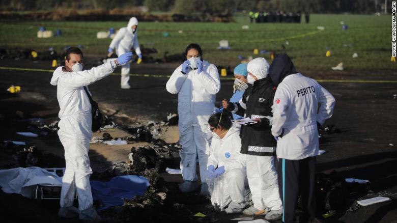 Forensic doctors work at the scene of the pipeline explosion January 19.