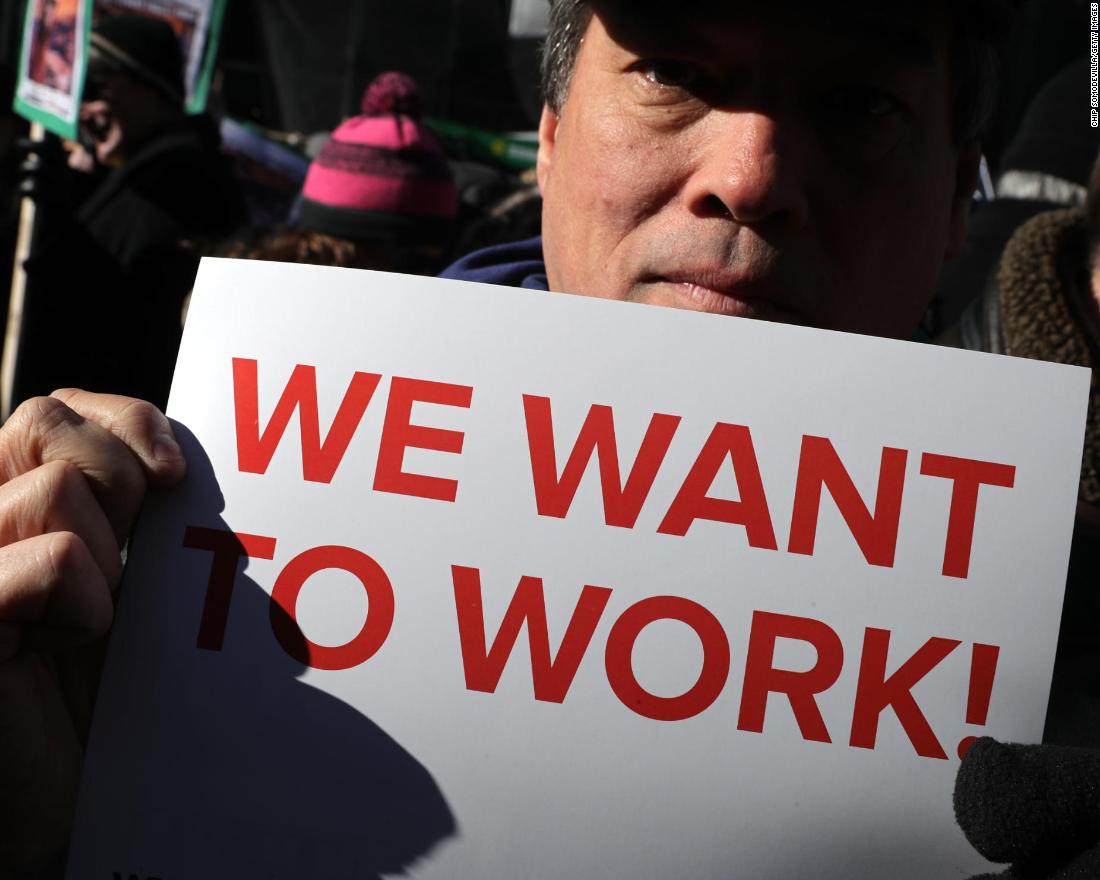 Federal workers and contractors rally against the government shutdown outside the AFL-CIO headquarters in Washington on Thursday, January 10.