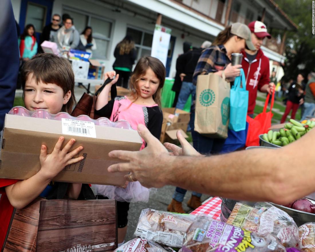 US Coast Guard families receive free groceries during a food giveaway organized by the San Francisco-Marin Food Bank and the North Bay Coast Guard Spouses Club on Saturday, January 19, in Novato, California.