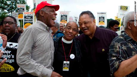 Actor Danny Glover, left, and the Rev. Jesse Jackson, right, march with others outside the US Capitol during the Poor People's Campaign rally in Washington on June 23, 2018.