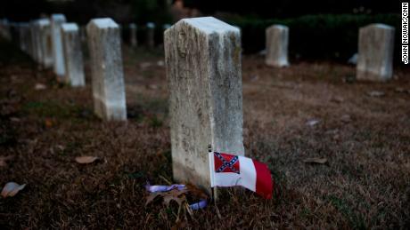 A Confederate flag adorns the grave of a Confederate soldier in Oakland Cemetery.