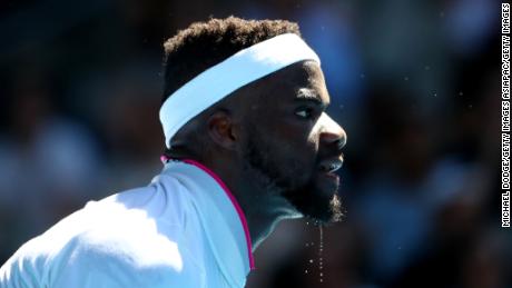 Frances Tiafoe of the United States serves in his fourth round match against Grigor Dimitrov of Bulgaria.