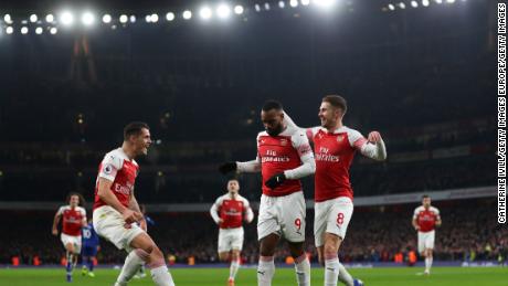 Arsenal's French striker Alexandre Lacazette celebrates scoring his team's first goal with teammates Granit Xhaka and Aaron Ramsey.