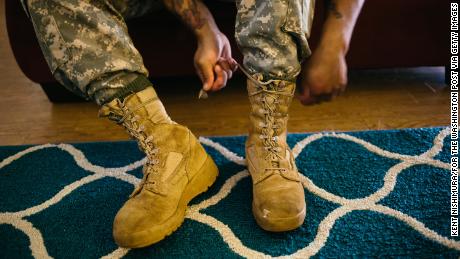 WAHIAWA, HAWAII - MARCH 26:  Army Sergeant Shane Ortega laces up boots before posing for a portrait at home at Wheeler Army Airfield on March 26, 2015 in Wahiawa, Hawaii.  (Photo by Kent Nishimura/For The Washington Post via Getty Images)