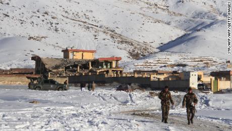 Afghan security forces walks near a site after a car bomb attack on a military base in the central province of Maidan Wardak on Monday.