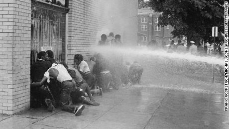Firefighters use fire hoses to subdue black civil rights protesters in Birmingham, Alabama, May 1963. 