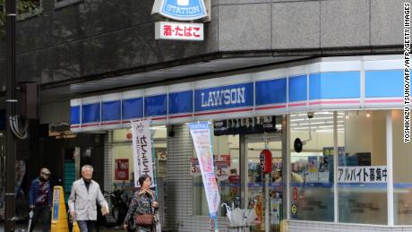 This 2015 image shows pedestrians walking past an outlet of Japan's second largest convenience chain, Lawson, in Yokohama, near the capital Tokyo.