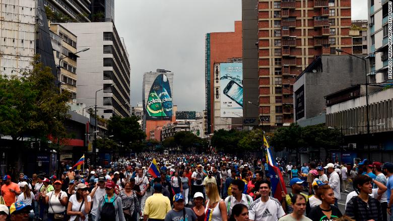 Opposition supporters take part Wednesday in a Caracas march on the anniversary of a 1958 uprising.