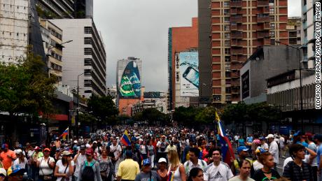 Opposition supporters take part Wednesday in a Caracas march on the anniversary of a 1958 uprising.