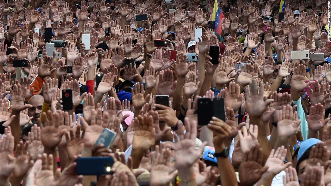 People raise their hands to show solidarity with Guaido, who was declaring himself interim president on January 23.