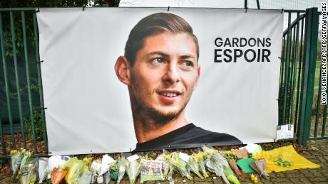 Flowers placed under a portrait of Sala in Nantes.