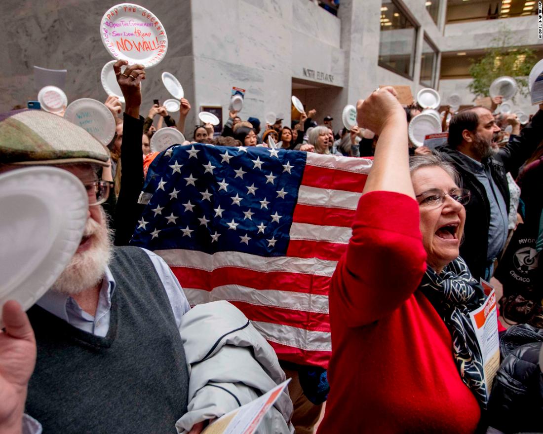 Furloughed government workers protest against the shutdown on Capitol Hill on Wednesday, January 23. As the shutdown dragged on, more federal employees were called back to work -- without pay -- to keep key things running smoothly. 