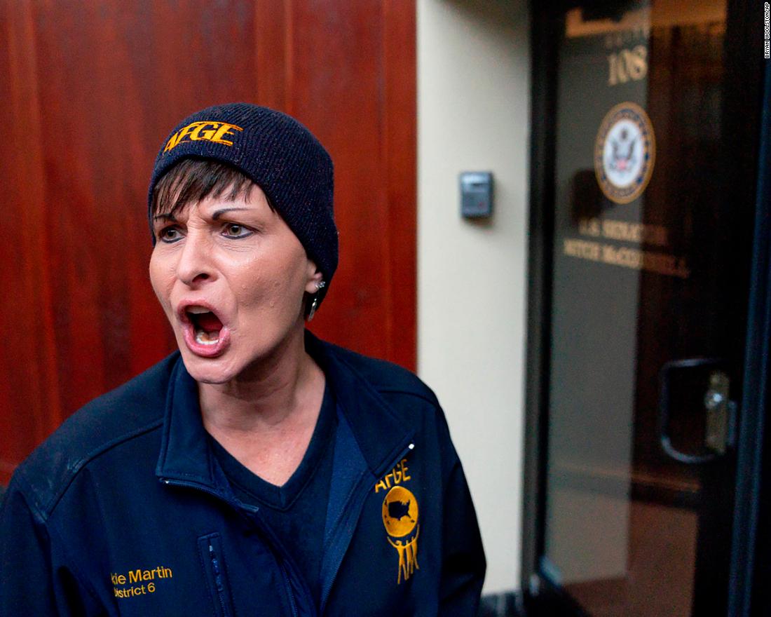 Vickie Martin, president of the American Federation of Government Workers Local 1438, reacts to the locked door of US Sen. Mitch McConnell&#39;s office in Lexington, Kentucky, during a January 23 protest.