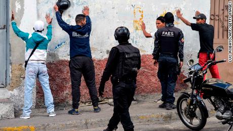 Special forces police detain a group of men during an operation in the Petare neighborhood of Caracas on Friday.