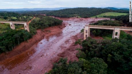 An aerial view shows a collapsed bridge after flooding from a breached dam Friday in southeast Brazil.