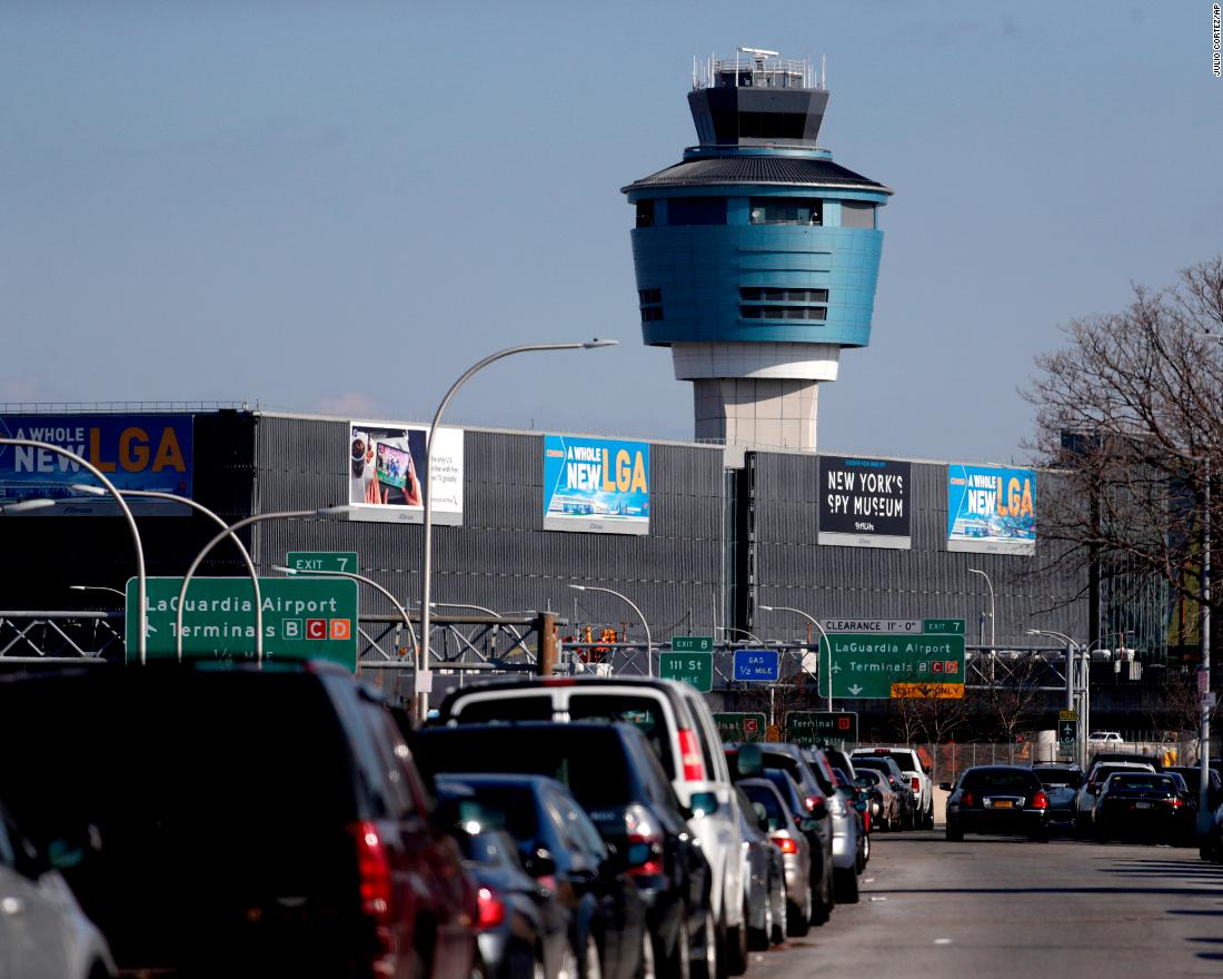 The air traffic control tower at New York&#39;s LaGuardia Airport on January 25. The Federal Aviation Administration reported delays in air travel because of a &quot;slight increase in sick leave&quot; at two East Coast air traffic control facilities.