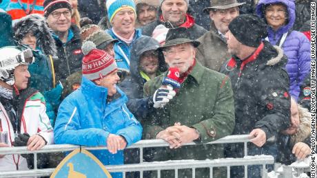 Arnold Schwarzenegger watches racing from the grandstand in Kitzbuhel.